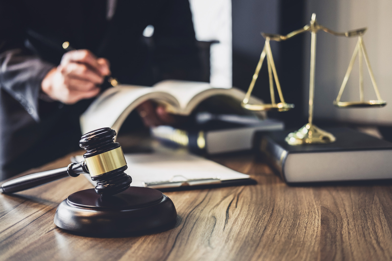 Criminal defence lawyers in Brisbane handling traffic offences, with gavel, scales of justice and legal files.